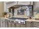 Modern kitchen with custom cabinetry, gas cooktop, and decorative tile backsplash at 2145 Jones Phillips Rd, Dacula, GA 30019