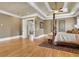 Main bedroom with hardwood floors, four-poster bed, and access to another room at 2145 Jones Phillips Rd, Dacula, GA 30019