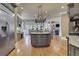 Open kitchen with large island, stainless steel appliances, and hardwood floors at 2145 Jones Phillips Rd, Dacula, GA 30019