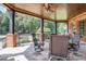 Relaxing covered patio with stone flooring, wicker furniture, and a view of the backyard at 2145 Jones Phillips Rd, Dacula, GA 30019