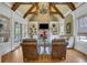 Two-story living room with hardwood floors, stone fireplace, and built-in shelving at 2145 Jones Phillips Rd, Dacula, GA 30019