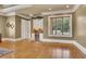 Spacious sitting room with hardwood floors, built-in cabinetry, and large window at 2145 Jones Phillips Rd, Dacula, GA 30019