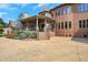 House exterior showcasing a brick facade, covered patio, and landscaped grounds at 2145 Jones Phillips Rd, Dacula, GA 30019