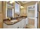 Double vanity bathroom with granite countertops and a large mirror at 2145 Jones Phillips Rd, Dacula, GA 30019
