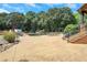 Spacious pool area with concrete decking, lounge chairs, and a view of the woods at 2145 Jones Phillips Rd, Dacula, GA 30019