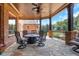 Covered patio features a fire pit table and comfortable seating for outdoor entertaining at 2145 Jones Phillips Rd, Dacula, GA 30019