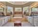 Large Primary bathroom with soaking tub, double vanities, and lots of natural light at 2145 Jones Phillips Rd, Dacula, GA 30019