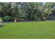 Large grassy backyard with playset, providing ample space for recreation at 2145 Jones Phillips Rd, Dacula, GA 30019