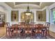 Elegant formal dining room with a large table, chandelier, and hardwood floors at 2145 Jones Phillips Rd, Dacula, GA 30019