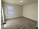 Spacious bedroom with neutral carpeting and a window at 3627 Lockaby Way, Lawrenceville, GA 30044
