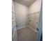Bright laundry room with tile floor and ample shelving at 3627 Lockaby Way, Lawrenceville, GA 30044