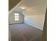 Spacious bonus room with neutral carpeting and large window at 3627 Lockaby Way, Lawrenceville, GA 30044