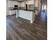 Modern kitchen with island and hardwood floors at 3627 Lockaby Way, Lawrenceville, GA 30044