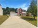 Two story brick home with attached garage and driveway at 2959 Heather Lake Dr, Austell, GA 30106