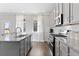 Kitchen with gray cabinets, granite countertops, and stainless steel appliances at 3646 Lockaby Way, Lawrenceville, GA 30044