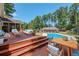Spacious deck with seating area overlooking the pool and backyard at 3060 Orchard Sw Rd, Conyers, GA 30094