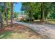 Long driveway leading to two story house with large yard at 3060 Orchard Sw Rd, Conyers, GA 30094