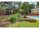 Landscaped backyard with a stone koi pond at 3060 Orchard Sw Rd, Conyers, GA 30094