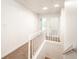 Upstairs hallway with carpeted flooring and railing at 3060 Orchard Sw Rd, Conyers, GA 30094
