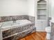 Bathroom features a jetted tub and built-in shelving at 3060 Orchard Sw Rd, Conyers, GA 30094