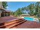Large deck with multiple seating areas and pool access at 3060 Orchard Sw Rd, Conyers, GA 30094