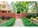 Brick wall entryway with lush landscaping and steps leading to the home at 3060 Orchard Sw Rd, Conyers, GA 30094