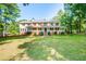 Two-story house with wrap-around porch and spacious lawn at 3060 Orchard Sw Rd, Conyers, GA 30094