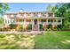 Two-story house with wrap-around porch, brick accents, and landscaped yard at 3060 Orchard Sw Rd, Conyers, GA 30094