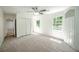 Bright bedroom with carpet, double closet, and built-in shelving at 3060 Orchard Sw Rd, Conyers, GA 30094
