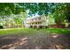 Two-story house with wrap-around porch, and lush landscaping at 3060 Orchard Sw Rd, Conyers, GA 30094