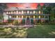 Two-story house with wrap-around porch, brick accents, and well-lit landscaping at 3060 Orchard Sw Rd, Conyers, GA 30094