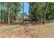 Two story house nestled among tall trees on a large lot at 3060 Orchard Sw Rd, Conyers, GA 30094