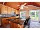 Pool house kitchen with granite island and wood cabinets at 3060 Orchard Sw Rd, Conyers, GA 30094