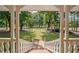 View from porch; grassy backyard with trees and a fence at 3060 Orchard Sw Rd, Conyers, GA 30094