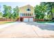 Two-car garage with large driveway and landscaping at 3060 Orchard Sw Rd, Conyers, GA 30094
