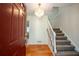 Two-story entryway with hardwood floors, chandelier, and red door at 3060 Orchard Sw Rd, Conyers, GA 30094