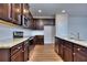 Spacious kitchen with dark wood cabinetry and granite countertops at 6202 Ripple Way # 88, South Fulton, GA 30349