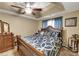 Main bedroom with a king-size bed and ceiling fan at 160 Country Mill Ln, Stockbridge, GA 30281