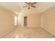 Spacious main bedroom with tray ceiling, carpet, and access to bathroom at 994 Rolling Forest Ln, Lilburn, GA 30047