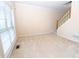 Bright living room with neutral carpet and staircase at 994 Rolling Forest Ln, Lilburn, GA 30047
