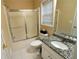 Bathroom with granite vanity, shower/tub combo and tile floors at 994 Rolling Forest Ln, Lilburn, GA 30047