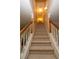 Elegant staircase with carpeted steps and wooden railings at 994 Rolling Forest Ln, Lilburn, GA 30047