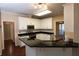 Kitchen with white cabinets, granite countertops and hardwood floors at 994 Rolling Forest Ln, Lilburn, GA 30047