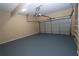 Spacious garage with painted floor, shelving, and an automatic garage door opener at 994 Rolling Forest Ln, Lilburn, GA 30047