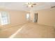 Large main bedroom with tray ceiling and carpet flooring at 994 Rolling Forest Ln, Lilburn, GA 30047