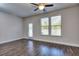 Bright living room with hardwood floors, ceiling fan, and door leading to the backyard at 6206 Ripple Way # 89, South Fulton, GA 30349
