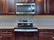 Kitchen features stainless steel appliances and dark wood cabinets at 6206 Ripple Way # 89, South Fulton, GA 30349