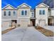 Tan and gray townhouses with attached garages and landscaping at 6206 Ripple Way # 89, South Fulton, GA 30349