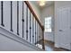 Bright and spacious entryway with elegant staircase and dark wood railing at 6206 Ripple Way # 89, South Fulton, GA 30349