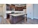 Kitchen island with granite countertop and dark wood cabinets at 6206 Ripple Way # 89, South Fulton, GA 30349